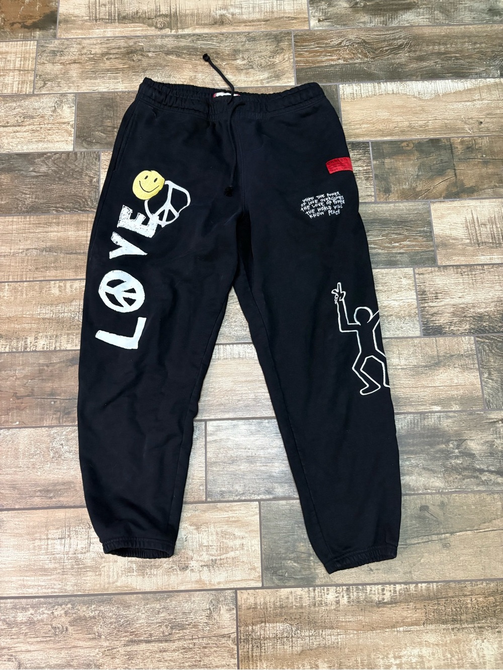CHNGE Black Sweatpants with White 'LOVE' Graphic and Yellow Smiley